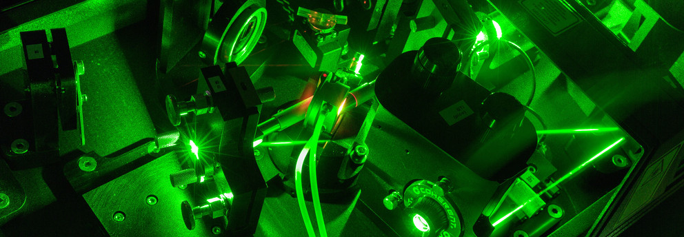 A detail shot of a laser in the lab in dark green colors.